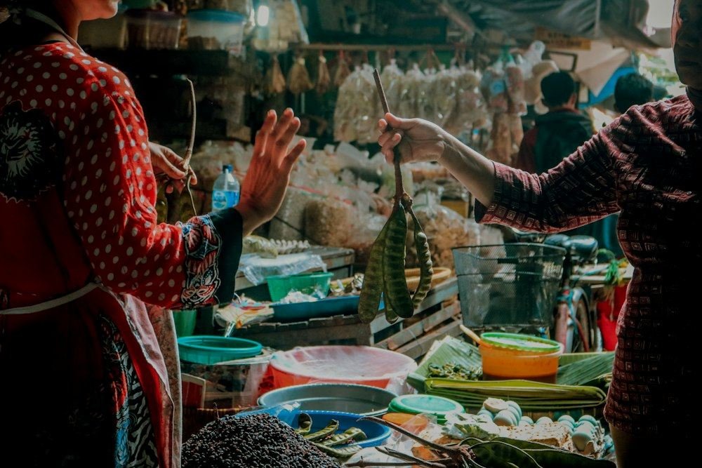 Women at a produce stall in an Indonesian traditional market