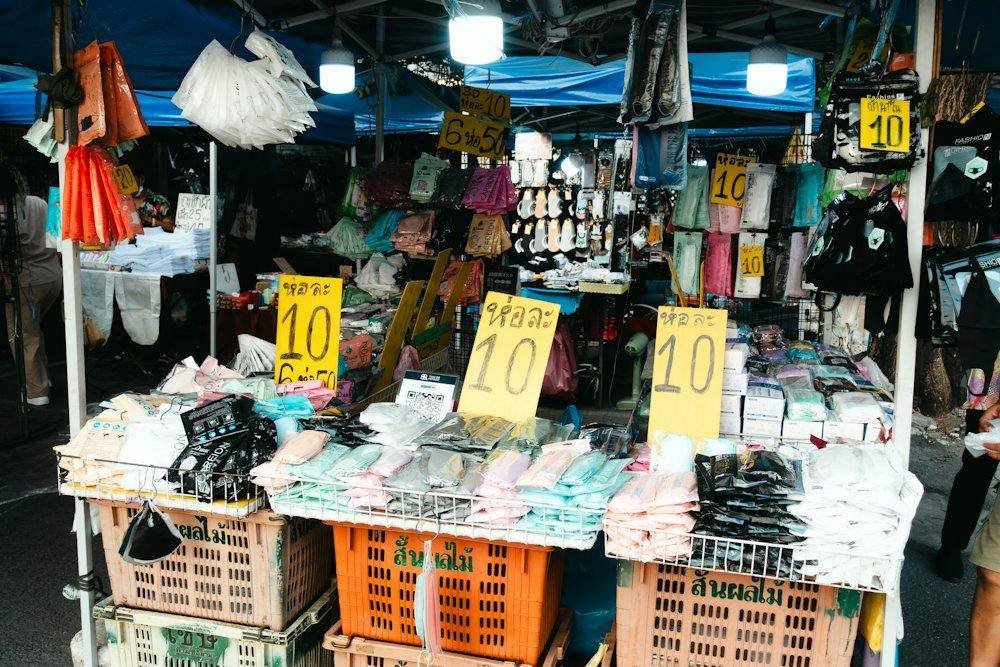 A vendor at a small retail market stall in Bangkok, Thailand