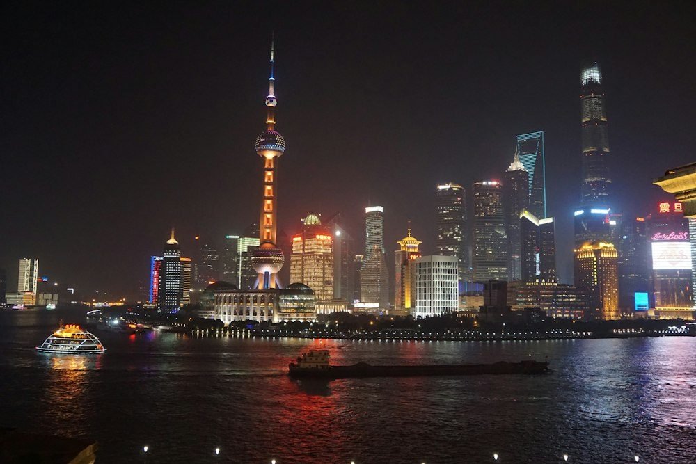 Shanghai Pudong skyline illuminated at night across the Huangpu River