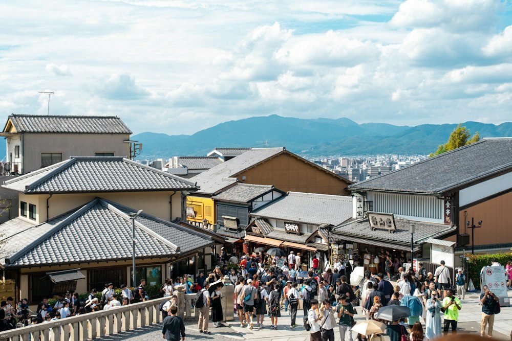 Visitors walk through a traditional shopping street in Kyoto, Japan