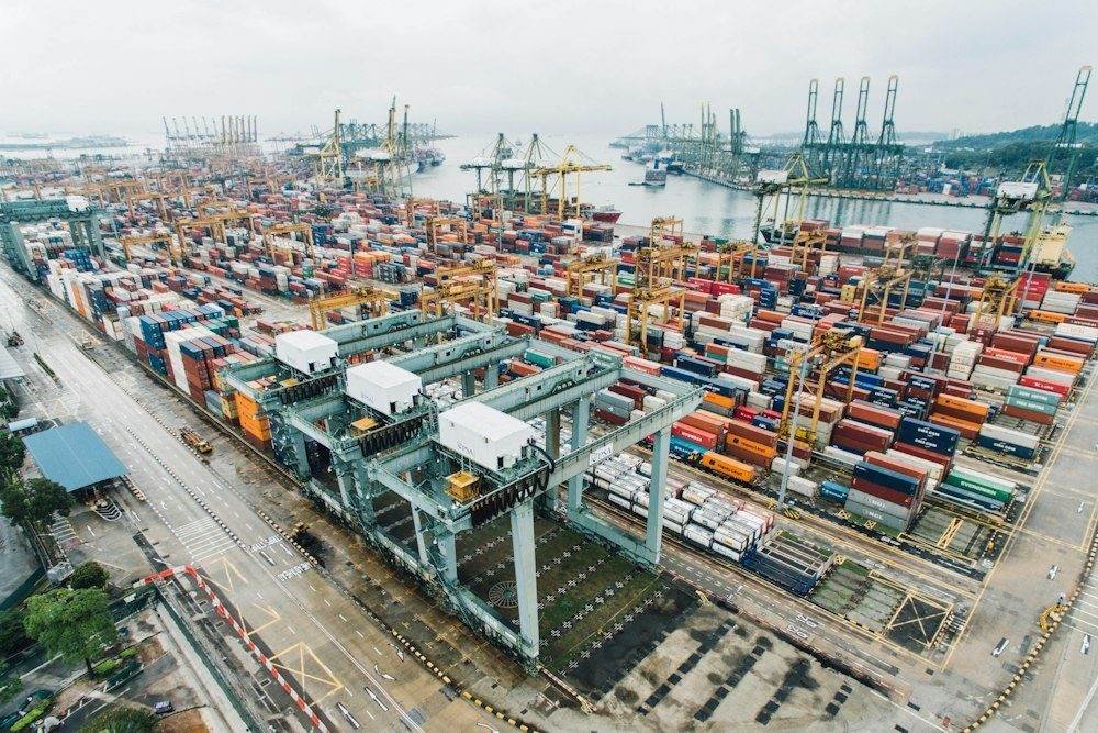Intermodal shipping containers, gantry cranes and quays at a Singapore cargo port