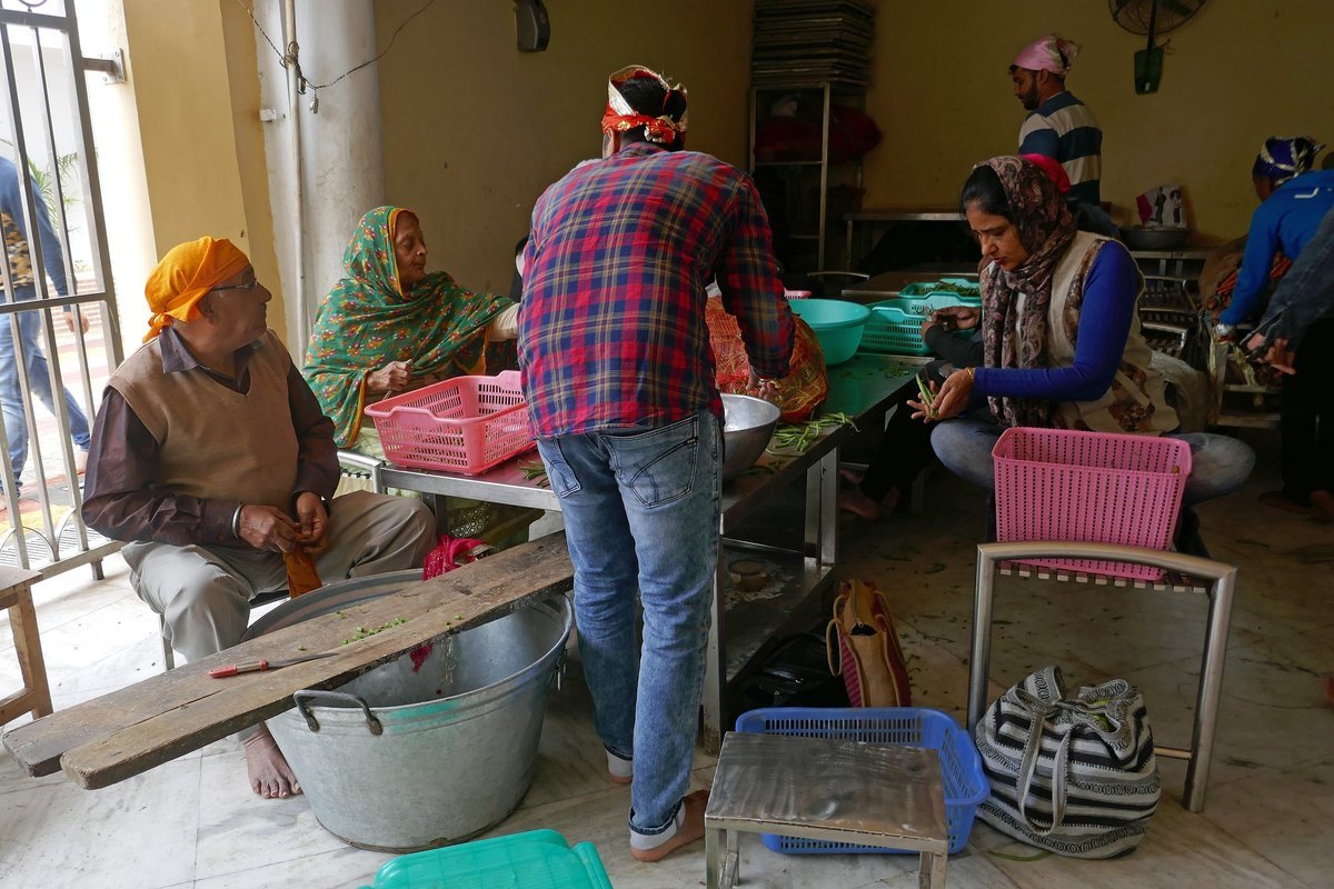 Volunteers preparing vegetables for a free community meal