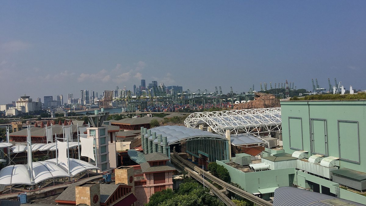 Container cranes and stacked shipping containers at a Singapore port terminal, representing trade-driven economic output