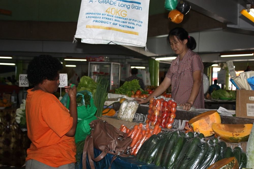 Women buying and selling vegetables at Suva Market in Fiji